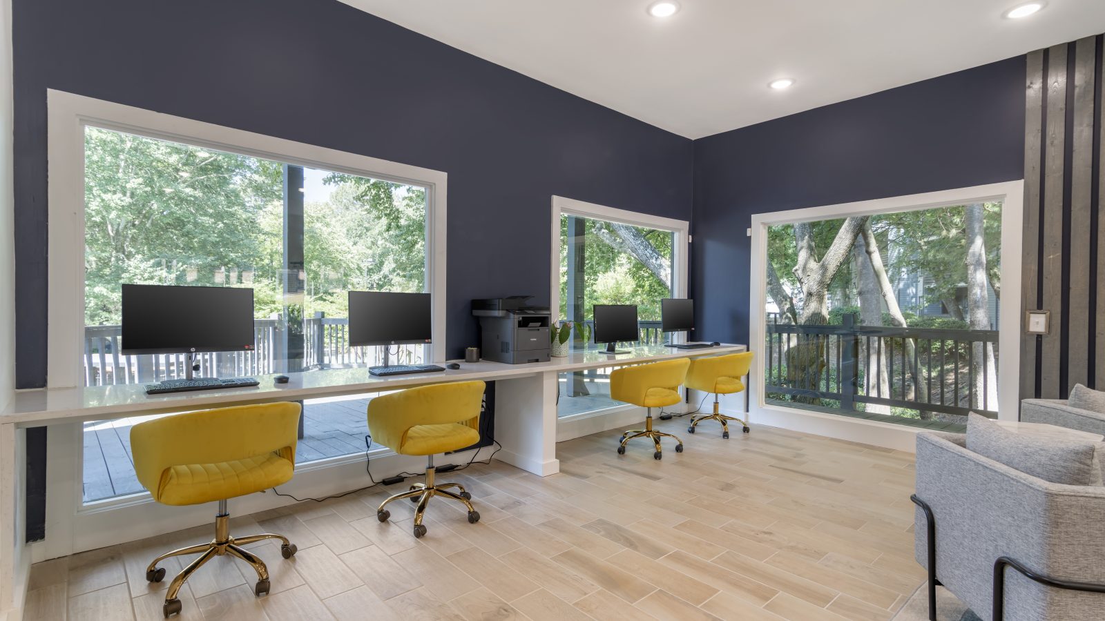 a home office with blue walls and yellow chairs at The  Jaxon